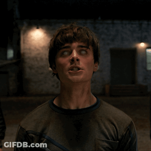 A Man With His Eyes Closed Looks Up At The Camera GIF