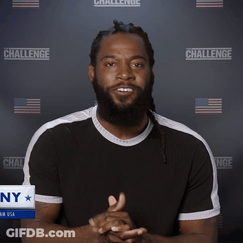 A Man With His Eyes Closed Stands In Front Of A Wall That Says The Challenge GIF