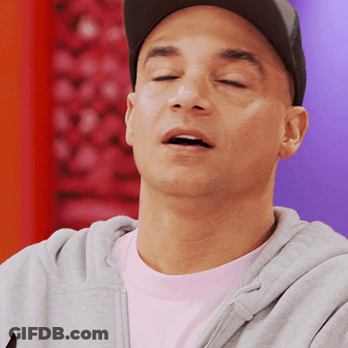 A Man With His Eyes Closed Wearing A Hat And A Gray Hoodie GIF