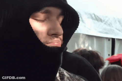 A Man With His Eyes Closed Wearing A Hooded Jacket GIF