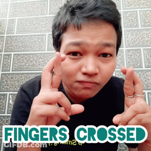A Man With His Fingers Crossed And The Words Fingers Crossed GIF