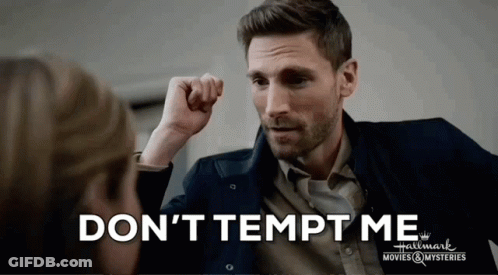 A Man With His Fist In The Air And The Words " Don 'T Tempt Me " Above Him GIF