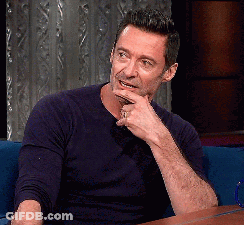 A Man With His Hand On His Chin And A Ring On His Finger GIF