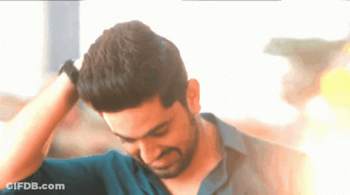 A Man With His Hand On His Head Looks Down GIF