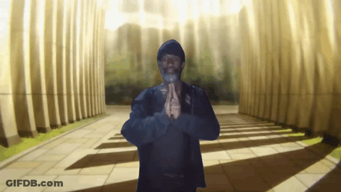 A Man With His Hands Folded In Front Of Columns GIF