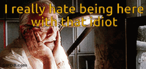 A Man With His Hands On His Face And The Words " I Really Hate Being Here With That Idiot " Behind Him GIF