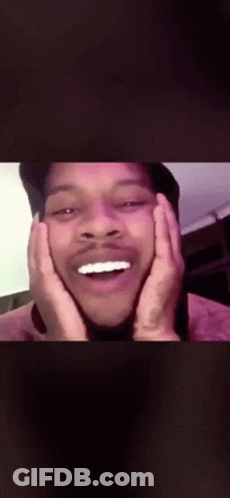 A Man With His Hands On His Face Is Laughing GIF