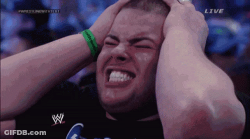 A Man With His Hands On His Head Is On A Wrestling Show GIF
