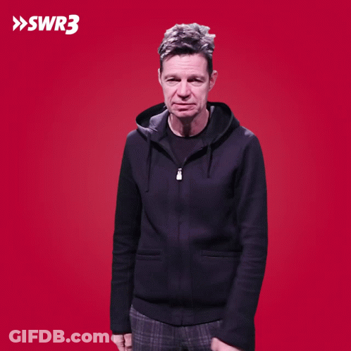 A Man With His Hands On His Hips Is Standing In Front Of A Red Background With Swr3 Written On It GIF