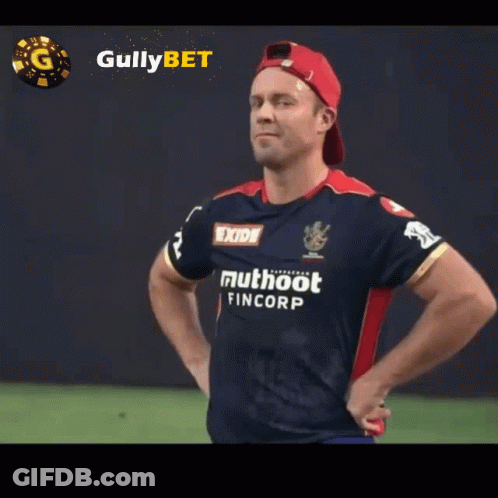 A Man With His Hands On His Hips Wears A Shirt That Says Exide Muthoot Fincorp GIF