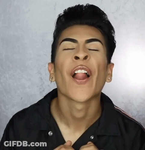 A Man With His Mouth Open And His Tongue Sticking Out GIF