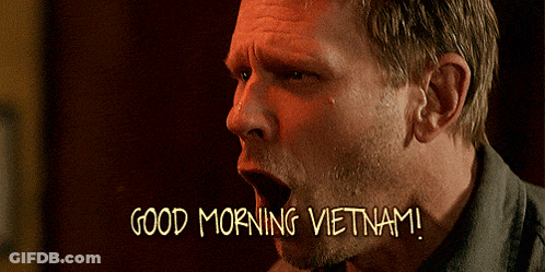 A Man With His Mouth Open And The Words Good Morning Vietnam Written Below Him GIF