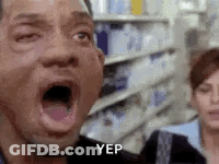 A Man With His Mouth Open In A Store With A Woman Behind Him . GIF