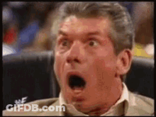 A Man With His Mouth Open Is Sitting In A Chair . GIF