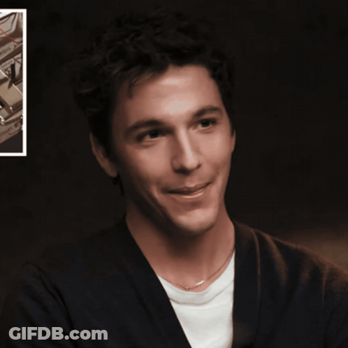 A Man With His Tongue Hanging Out Is Smiling GIF