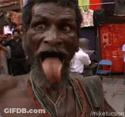 A Man With His Tongue Hanging Out Is Standing In Front Of A Clothesline GIF