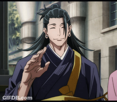 A Man With Long Black Hair And A Ponytail Is Smiling GIF