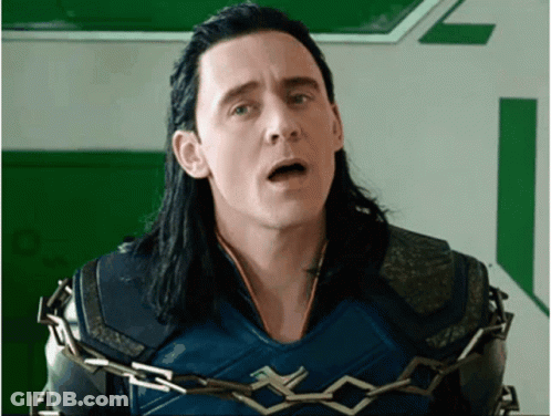 A Man With Long Black Hair Is Chained To A Wall With His Mouth Open . GIF