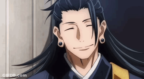 A Man With Long Black Hair Is Smiling With His Eyes Closed GIF