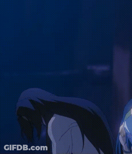 A Man With Long Black Hair Is Standing In A Dark Room With His Arms Outstretched GIF