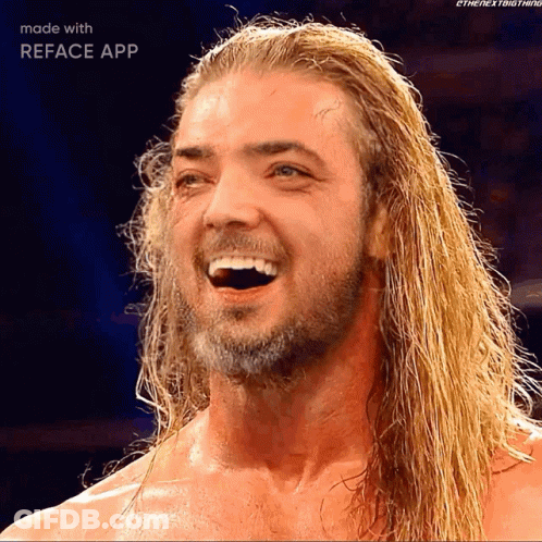 A Man With Long Blonde Hair And A Beard Is Smiling With The Reface App GIF