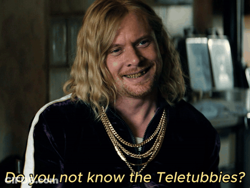 A Man With Long Blonde Hair And A Beard Is Smiling With The Words Do You Not Know The Teletubbies Below Him GIF