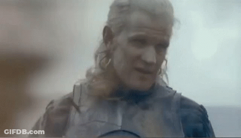 A Man With Long Blonde Hair And A Beard Is Wearing A Knight 'S Armor . GIF