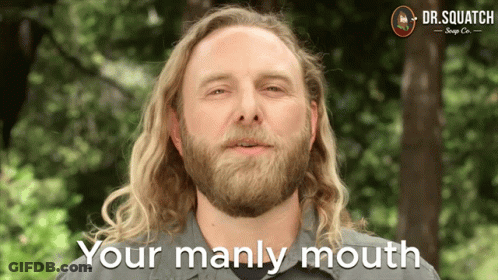 A Man With Long Blonde Hair And A Beard Says Your Manly Mouth GIF