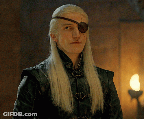 A Man With Long Blonde Hair And A Brown Eye Patch On His Forehead GIF