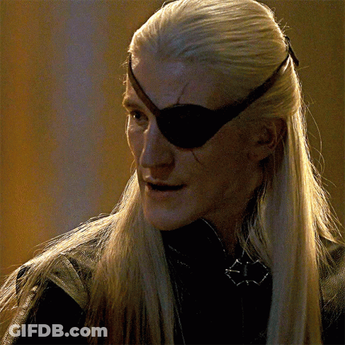 A Man With Long Blonde Hair And An Eye Patch On His Eye GIF
