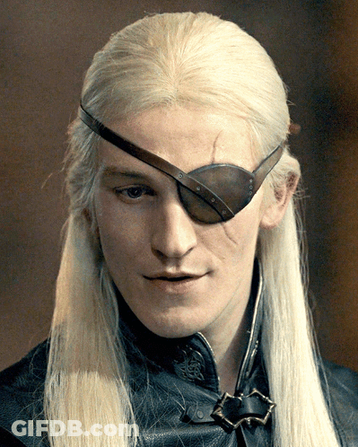 A Man With Long Blonde Hair Has A Brown Eye Patch On His Forehead GIF