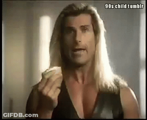 A Man With Long Blonde Hair Is Eating A Slice Of Pizza . GIF