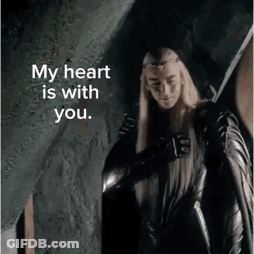 A Man With Long Blonde Hair Is Holding A Sword And Says My Heart Is With You . GIF
