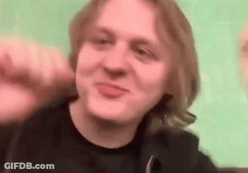 A Man With Long Blonde Hair Is Making A Funny Face While Making A Funny Face . GIF