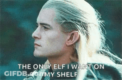 A Man With Long Blonde Hair Is Standing In Front Of A Blue Background And Says `` The Only Elf I Want On My Shelf '' . GIF