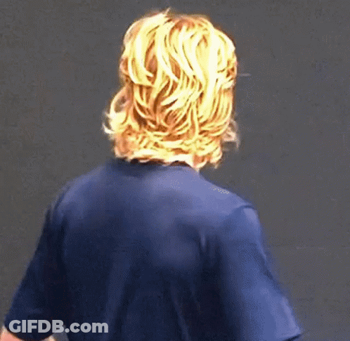 A Man With Long Blonde Hair Is Wearing A Blue Shirt . GIF