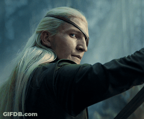 A Man With Long Blonde Hair Is Wearing A Pirate Eye Patch GIF