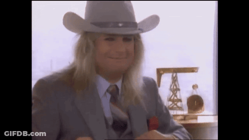 A Man With Long Blonde Hair Wearing A Cowboy Hat GIF