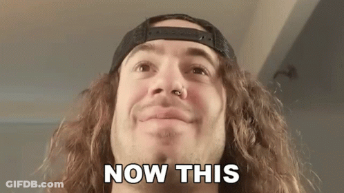 A Man With Long Curly Hair And A Nose Ring Is Smiling And Says Now This . GIF