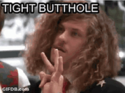 A Man With Long Curly Hair Is Making A Peace Sign And Says Tight Butthole In The Background . GIF