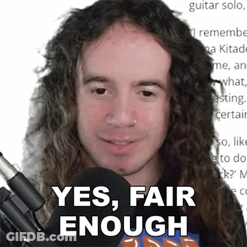 A Man With Long Curly Hair Is Smiling And Says Yes Fair Enough GIF