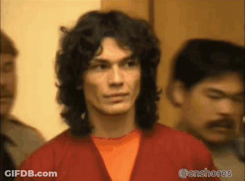 A Man With Long Curly Hair Is Standing In A Crowd Of People With The Hashtag @Snshores On The Bottom GIF