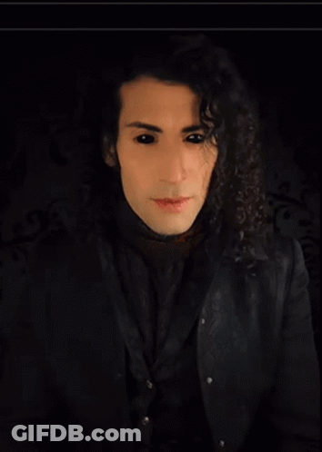 Man With Long Curly Hair In Black Shirt GIF