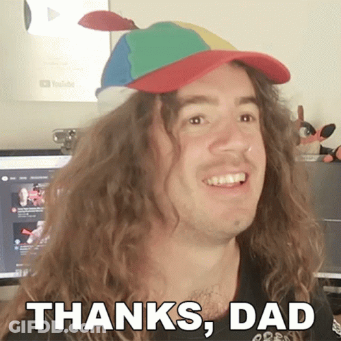 A Man With Long Curly Hair Is Wearing A Colorful Hat And Says Thanks Dad GIF