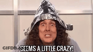 A Man With Long Curly Hair Is Wearing A Tin Foil Hat And Saying `` Seems A Little Crazy '' . GIF
