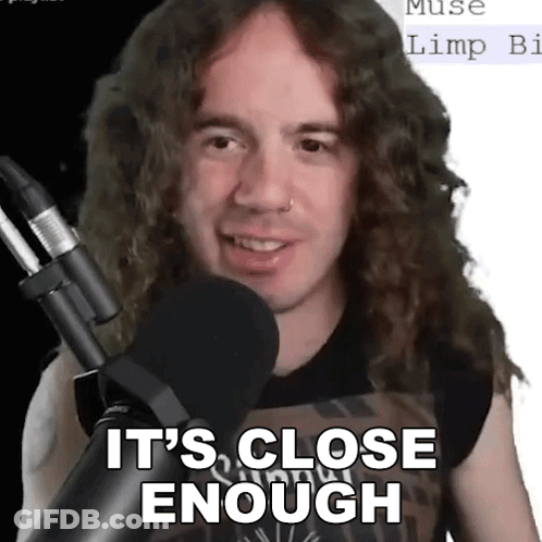 A Man With Long Curly Hair Stands In Front Of A Microphone And Says It 'S Close Enough . GIF