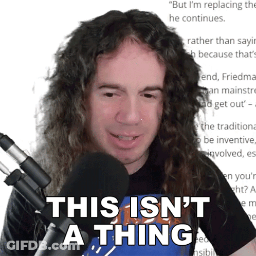A Man With Long Curly Hair Stands In Front Of A Microphone And Says This Isn 'T A Thing GIF