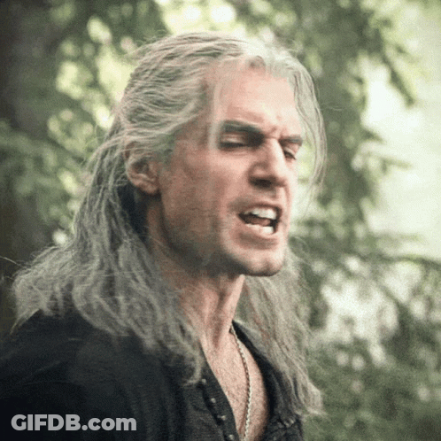 A Man With Long Gray Hair Making A Funny Face GIF