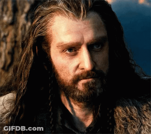 A Man With Long Hair And A Beard Has A Fur Coat On GIF