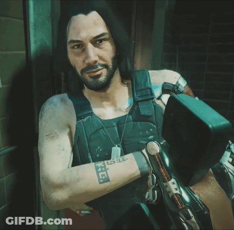 A Man With Long Hair And A Beard Has A Tattoo On His Arm That Says ' X ' GIF